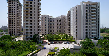 a rendering of a grandfather & his grandson playing in the park in sovereign park in vatika inxt 2 a project by vatika group