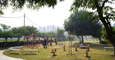 kids playing on the swings in the park in ambala vatika city central an integrated community living project by vatika group