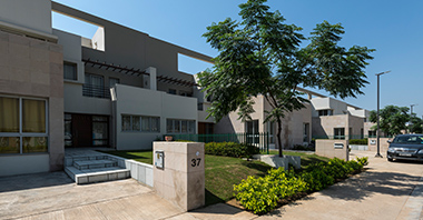 an outside view of the garden & frontside of the signature villa a project in vatika inxt  by vatika group