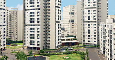 an aerial view of the park & the buildings of the sovereign apartments in gurgaon a project by vatika group