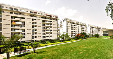 a view of garden & the buildings of vatika city in gurgaon a project by vatika group