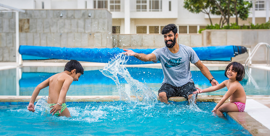 woman falling into swimming pool enjoying with family in gurgaon 21 by vatika india next by vatika group